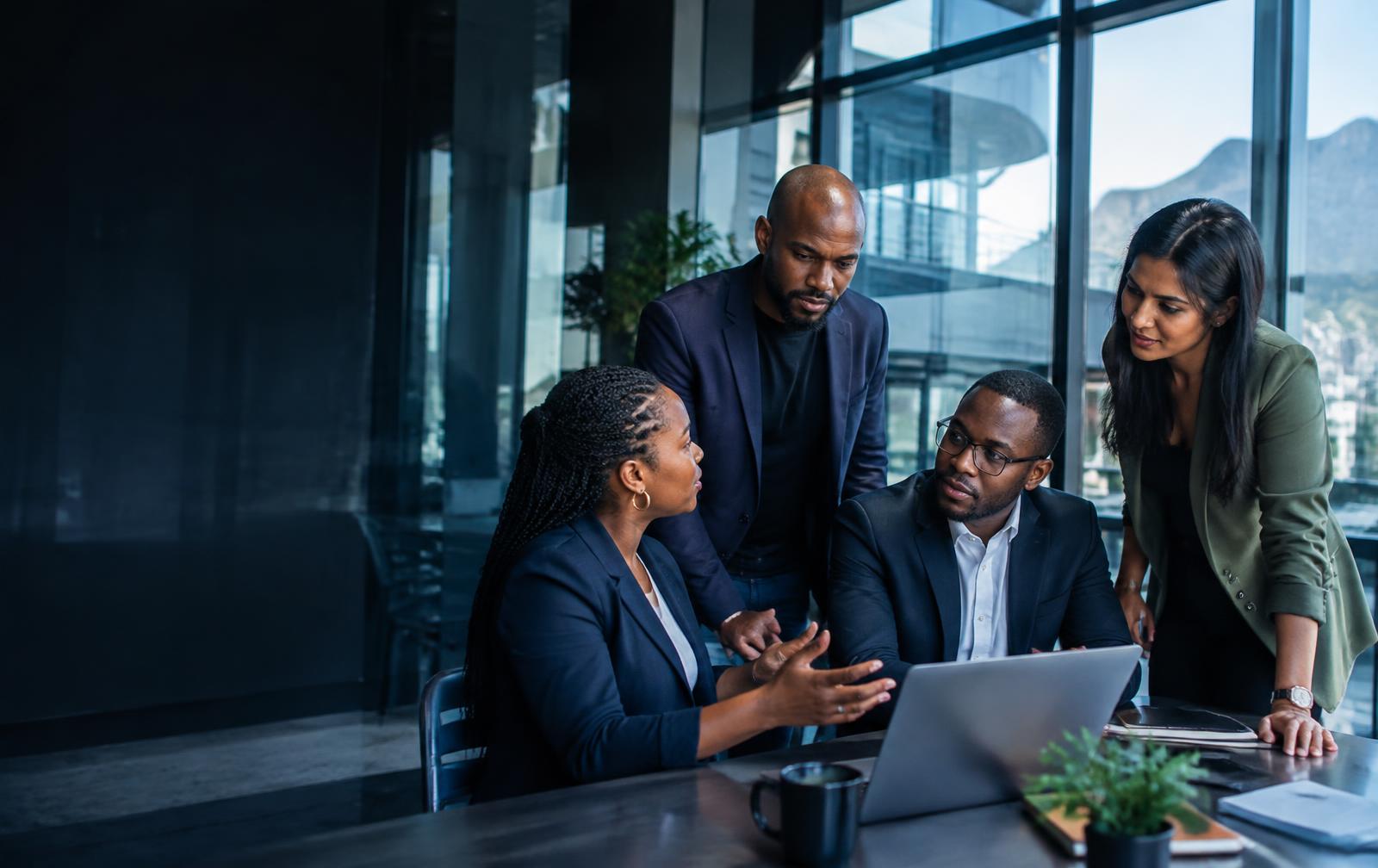 South African professionals collaborating in a modern glass workplace